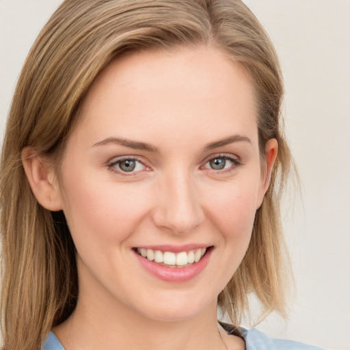 Joyful white young-adult female with long  brown hair and blue eyes