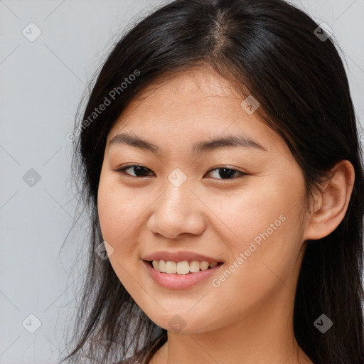 Joyful asian young-adult female with long  brown hair and brown eyes