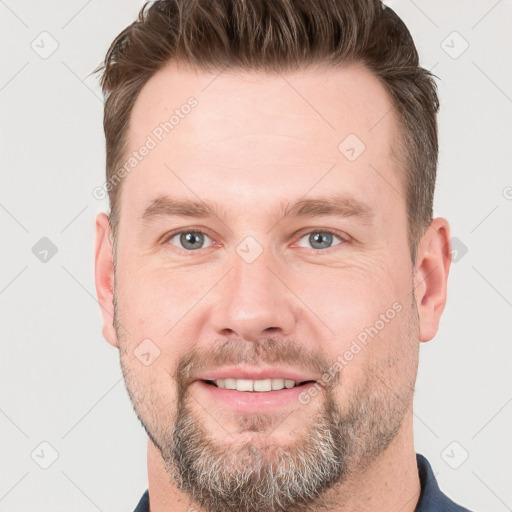 Joyful white adult male with short  brown hair and grey eyes