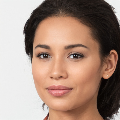 Joyful latino young-adult female with long  brown hair and brown eyes