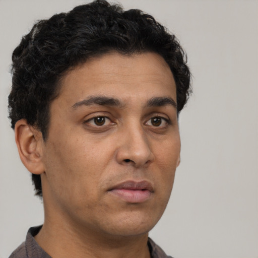 Neutral latino young-adult male with short  brown hair and brown eyes