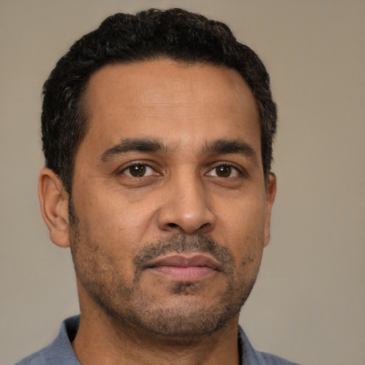 Neutral latino adult male with short  black hair and brown eyes