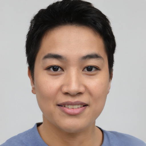 Joyful asian young-adult female with short  black hair and brown eyes