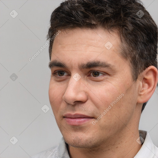 Joyful white adult male with short  brown hair and brown eyes