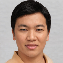 Joyful asian young-adult male with short  black hair and brown eyes