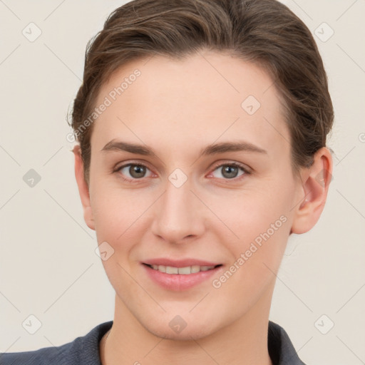 Joyful white young-adult female with short  brown hair and grey eyes