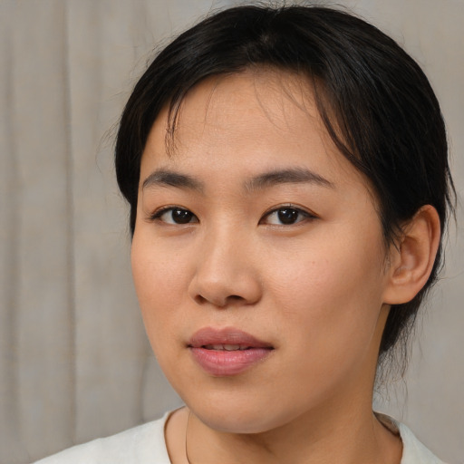 Joyful asian young-adult female with medium  brown hair and brown eyes