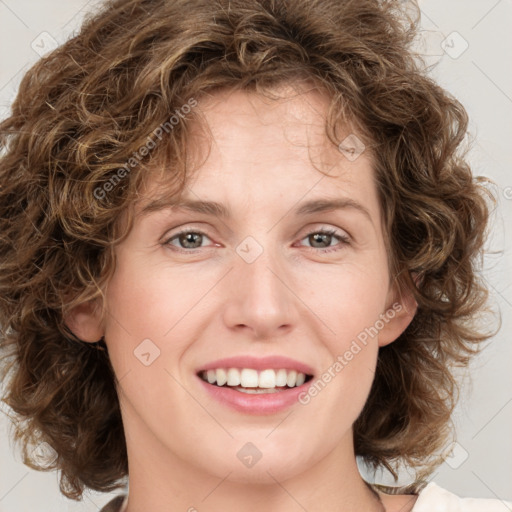 Joyful white young-adult female with medium  brown hair and green eyes