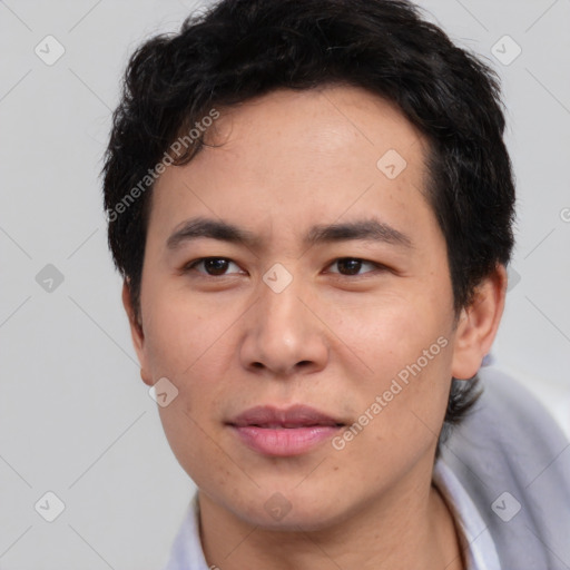 Joyful asian young-adult male with short  brown hair and brown eyes