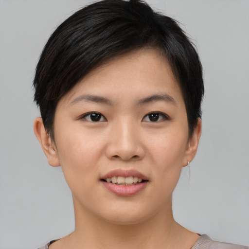 Joyful asian young-adult female with short  brown hair and brown eyes
