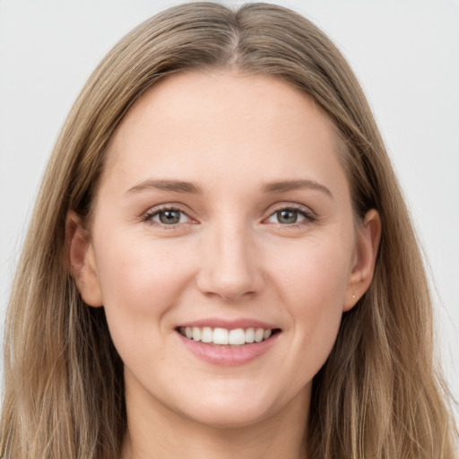 Joyful white young-adult female with long  brown hair and grey eyes