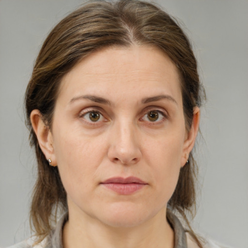 Joyful white adult female with medium  brown hair and brown eyes