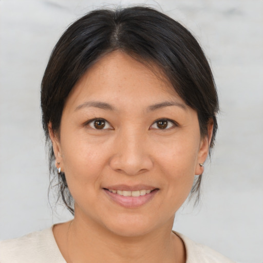 Joyful asian young-adult female with medium  brown hair and brown eyes