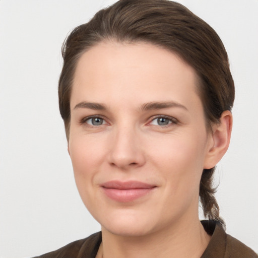 Joyful white young-adult female with short  brown hair and grey eyes