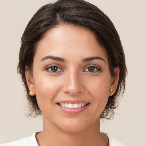 Joyful white young-adult female with medium  brown hair and brown eyes