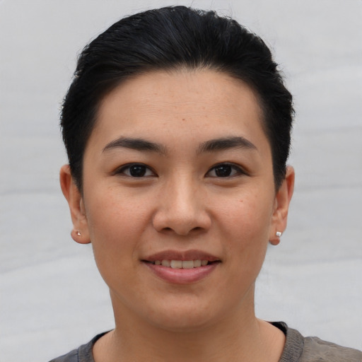 Joyful asian young-adult female with short  brown hair and brown eyes
