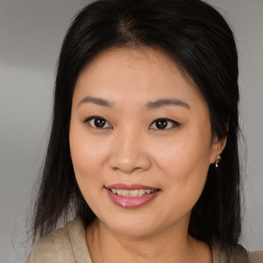 Joyful asian young-adult female with medium  brown hair and brown eyes
