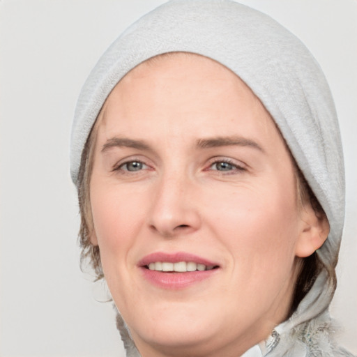 Joyful white adult female with medium  brown hair and blue eyes