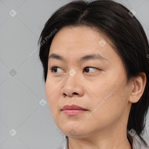 Joyful asian young-adult female with medium  brown hair and brown eyes