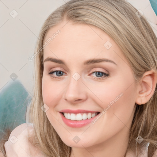 Joyful white young-adult female with long  brown hair and blue eyes