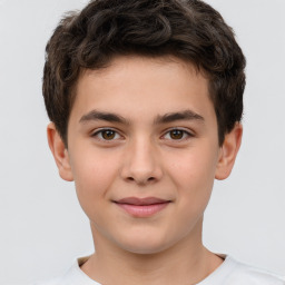 Joyful white child male with short  brown hair and brown eyes