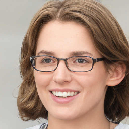 Joyful white young-adult female with medium  brown hair and blue eyes