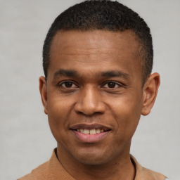 Joyful latino young-adult male with short  brown hair and brown eyes