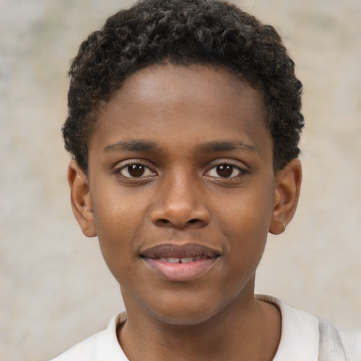 Joyful black child male with short  brown hair and brown eyes