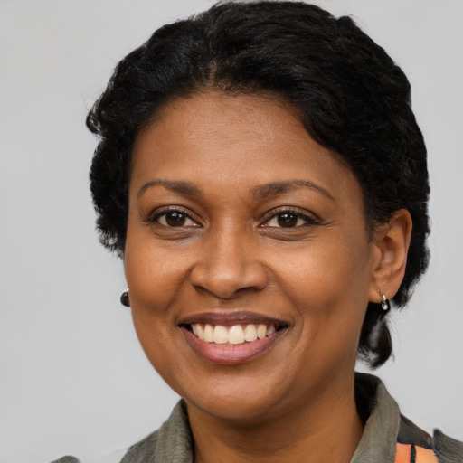Joyful latino adult female with short  brown hair and brown eyes