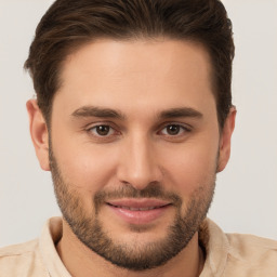 Joyful white young-adult male with short  brown hair and brown eyes