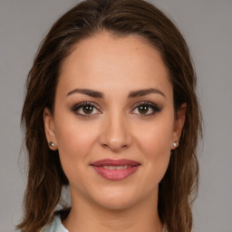 Joyful white young-adult female with medium  brown hair and brown eyes