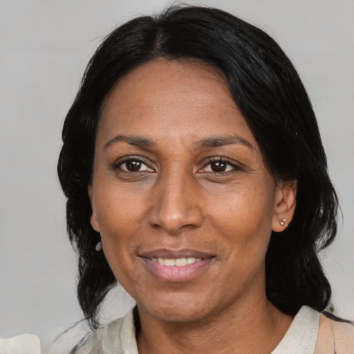 Joyful asian adult female with medium  black hair and brown eyes