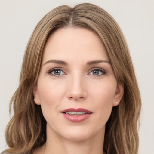 Joyful white young-adult female with long  brown hair and green eyes