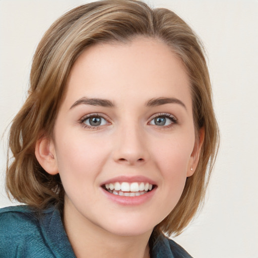 Joyful white young-adult female with medium  brown hair and blue eyes