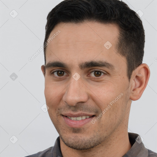 Joyful white young-adult male with short  brown hair and brown eyes