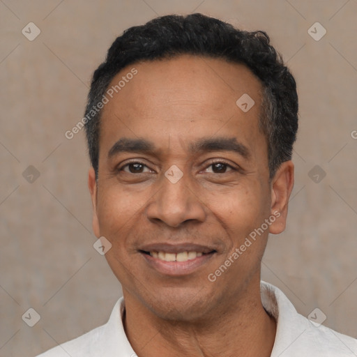 Joyful latino adult male with short  black hair and brown eyes