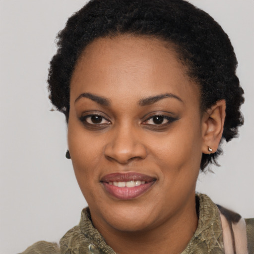 Joyful black young-adult female with short  brown hair and brown eyes