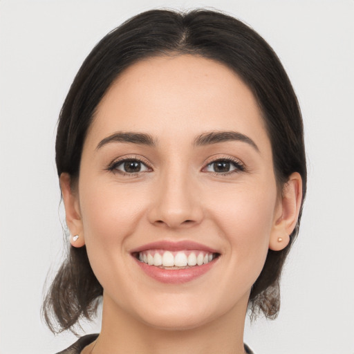 Joyful white young-adult female with medium  brown hair and brown eyes