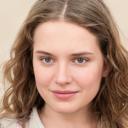 Joyful white young-adult female with long  brown hair and green eyes