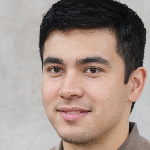 Joyful latino young-adult male with short  black hair and brown eyes