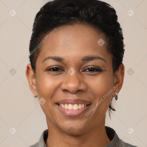 Joyful black young-adult female with short  brown hair and brown eyes