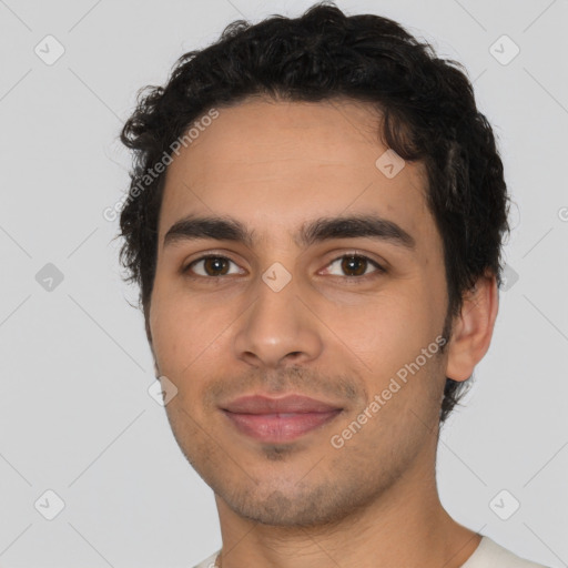 Joyful latino young-adult male with short  brown hair and brown eyes