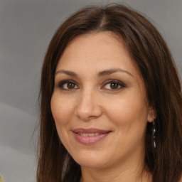 Joyful white adult female with long  brown hair and brown eyes