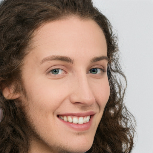 Joyful white young-adult female with long  brown hair and green eyes