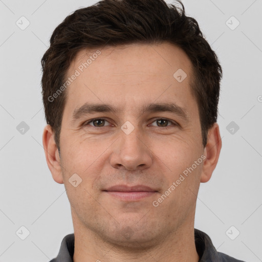 Joyful white adult male with short  brown hair and brown eyes