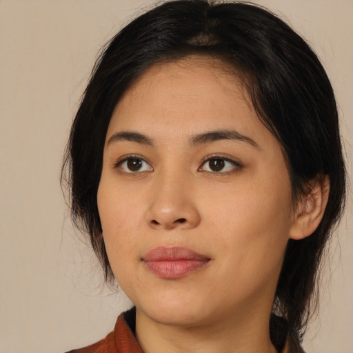Joyful asian young-adult female with medium  black hair and brown eyes