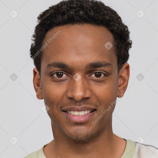 Joyful black young-adult male with short  black hair and brown eyes