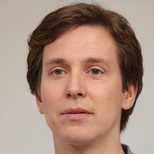 Joyful white adult male with short  brown hair and grey eyes