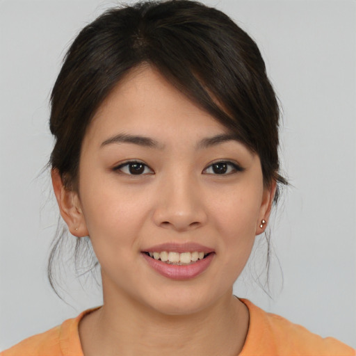Joyful asian young-adult female with medium  brown hair and brown eyes