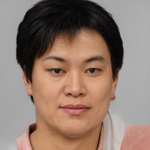 Joyful asian young-adult female with short  brown hair and brown eyes